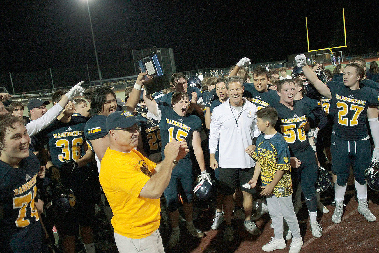 The Bainbridge football team, shown here celebrating their 2019 Agate Cup win over North Kitsap, will have to wait until March of 2021 to get a chance to defend the cup. (Review file photo)