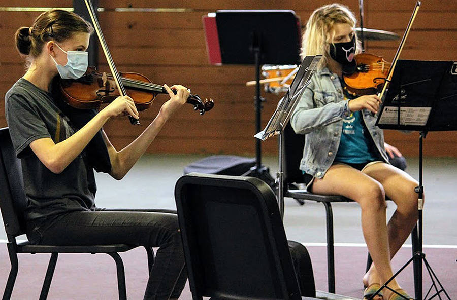 Along with wearing masks, these violinists sit about 6 feet apart as a safety precaution due to coronavirus restrictions.