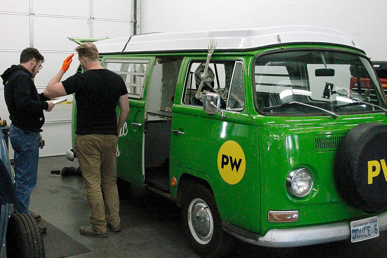 Mark Krulish|Kitsap News Group
EV Works technicians take a look at Joule, the shops electric Volkswagen bus.
