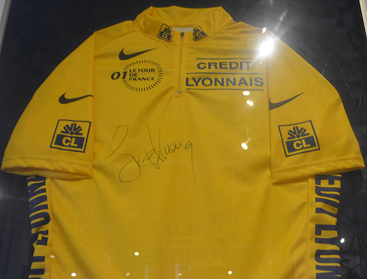 Lance Armstrong won this yellow shirt at the Tour de France and signed it. Seven of those races have no official winner because of his use of performing enhancement drugs.