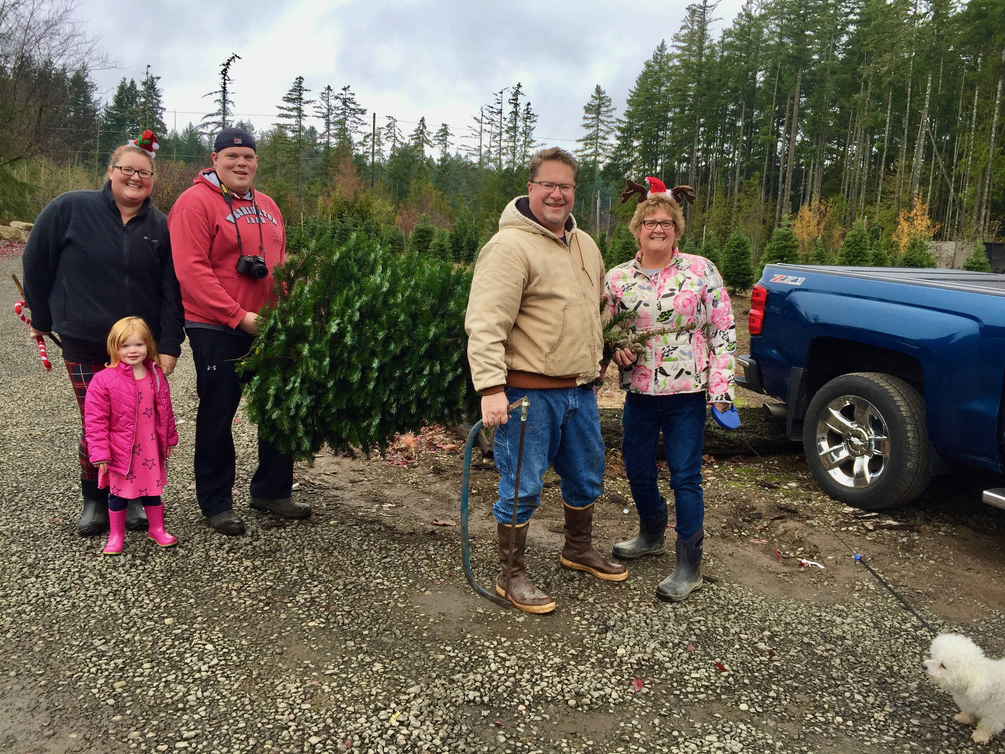 From 2019, a family successfully cuts down its own tree at the farm. Courtesy Olmstead Tree Farms