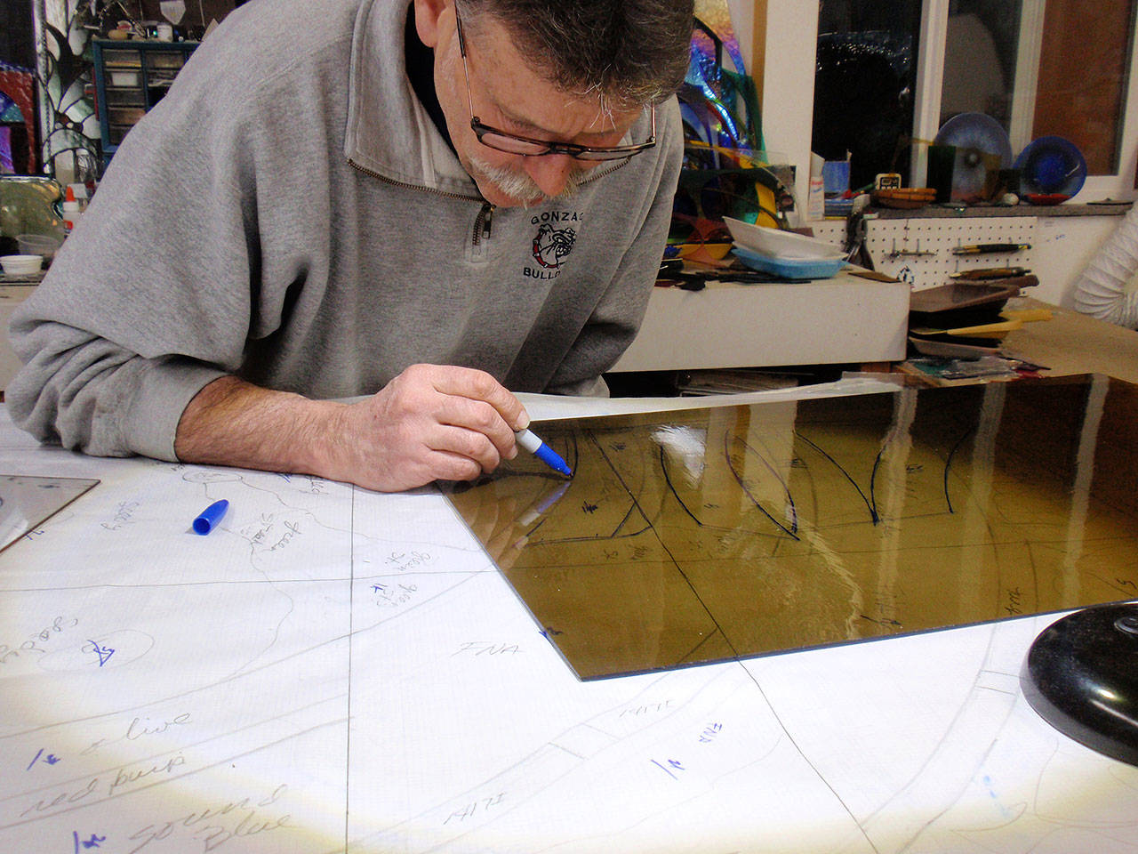 Greg Bonciolini working on the Kelly stained glass window. Courtesy Photo