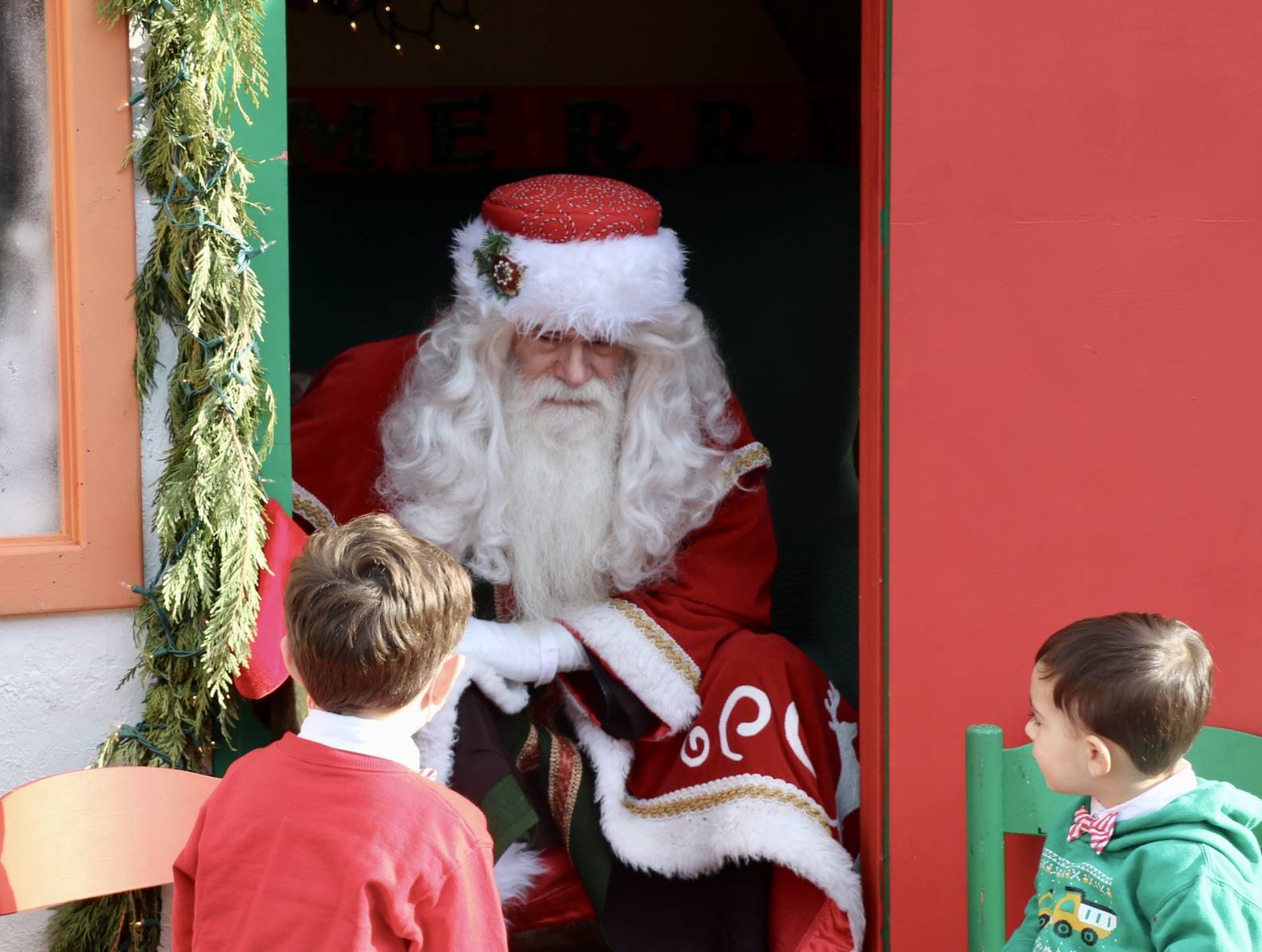 Santa chats with two boys about their Christmas wishes. KPark/NKH