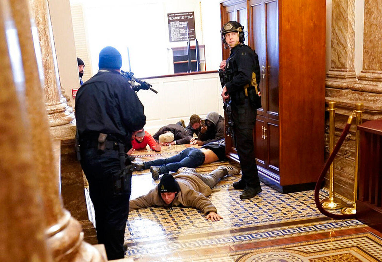 Capitol Police subdue insurrectionists who illegally entered the halls of the Capitol Building. (Courtesy of KUOW)