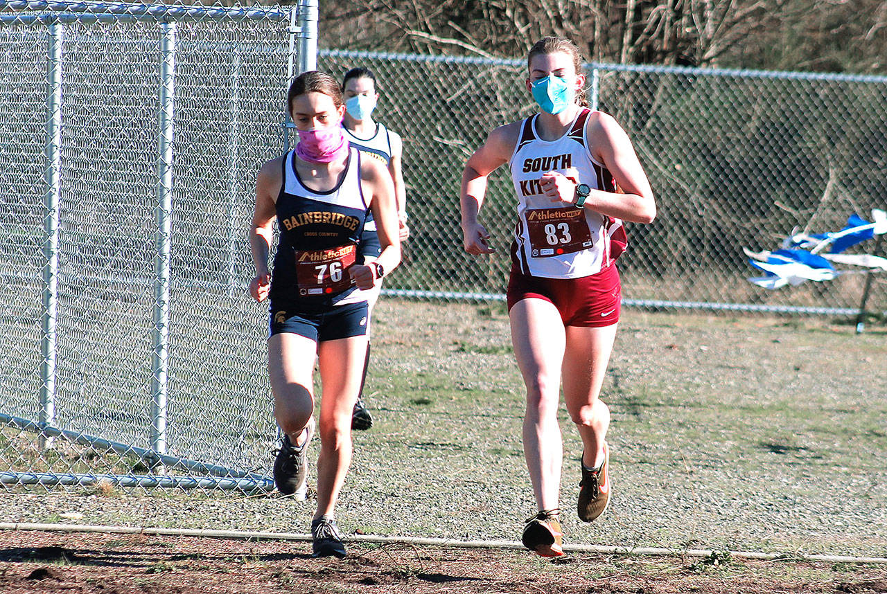 Bainbridge’s Eden Michael (left) and South Kitsap’s Evelyn Collins-Winn lead the pack during the first Olympic League meet of the season at North Mason High School. (Mark Krulish/Kitsap News Group)