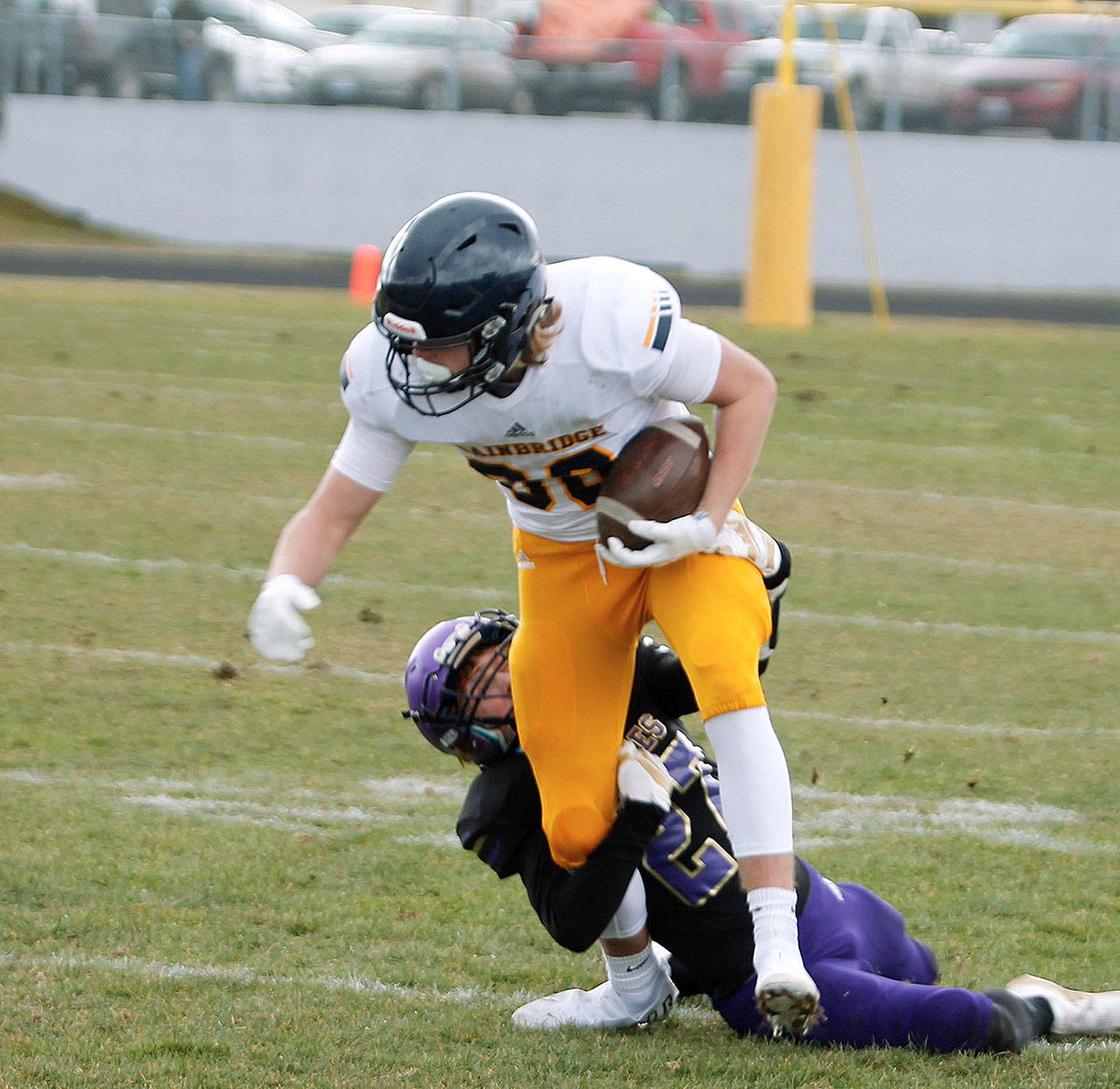 Alan Ullin tries to evade the grip of a Sequim tackler after making a catch. (Mark Krulish/Kitsap News Group)