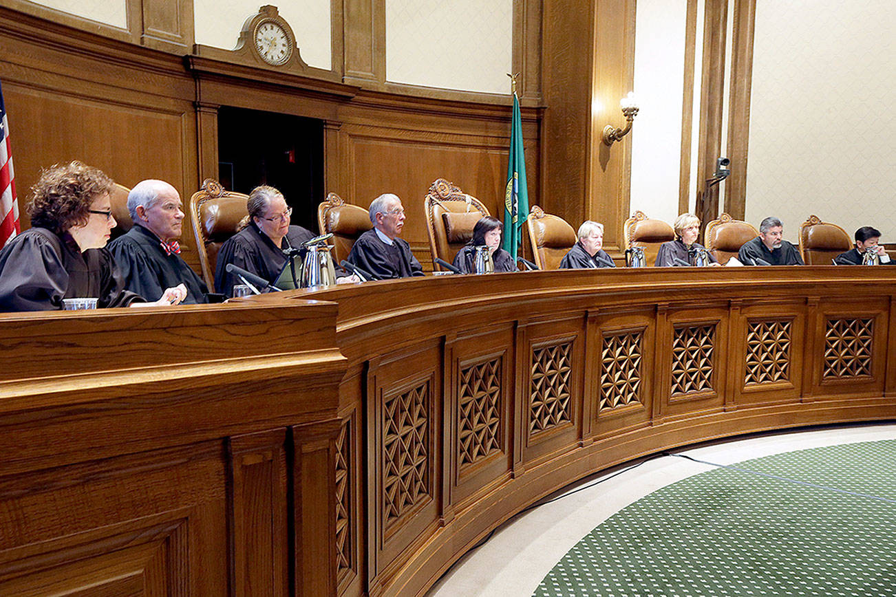 FILE - In this Sept. 7, 2016, file photo, Justices on the Washington state Supreme Court listen during a hearing in Olympia, Wash. Political groups are engaging in a high-stakes battle for institutions that were once considered above politics: state supreme courts. Both liberal and conservative groups now view control of the high courts as essential to either defending or thwarting state laws. (AP Photo/Ted S. Warren, File)
