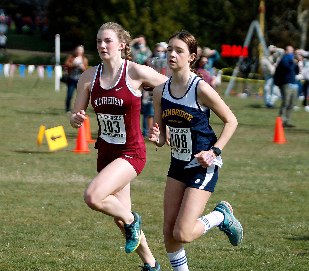 South Kitsap’s Evelyn Collins-Winn (left) and Bainbridge’s Lily Curtis take off from the starting line at the Olympic League varsity championships at Battle Point Park. (Mark Krulish/Kitsap News Group)
