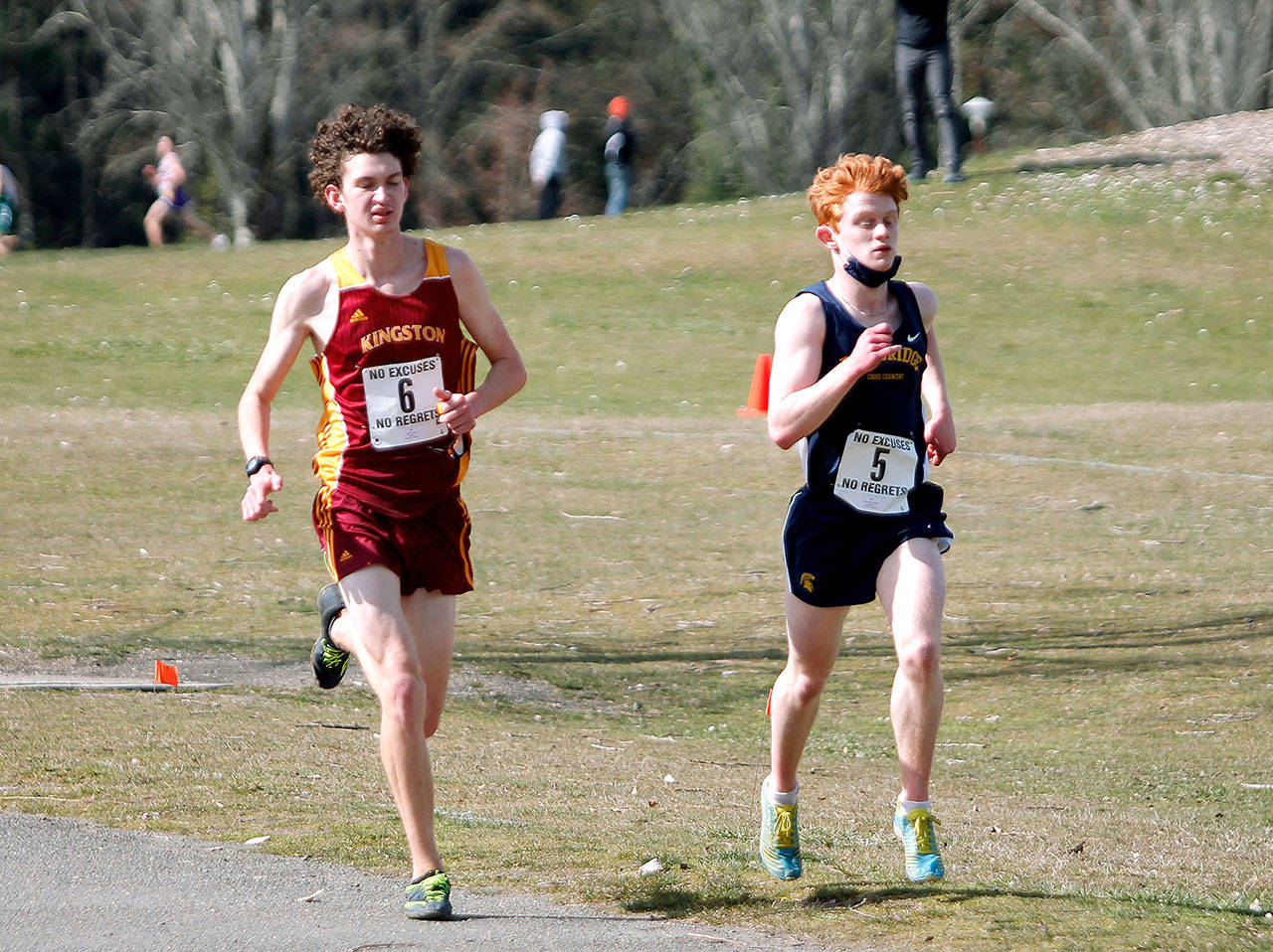 Kingston’s Curtis Upton (left) and Bainbridge’s Alex Miller (right) run neck-and-neck early in the championship race. (Mark Krulish/Kitsap News Group)