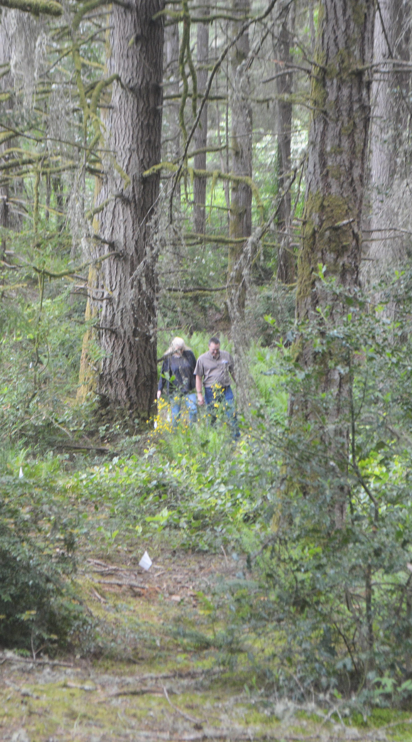 Janow and Hamlin hike up a hill on the property.
