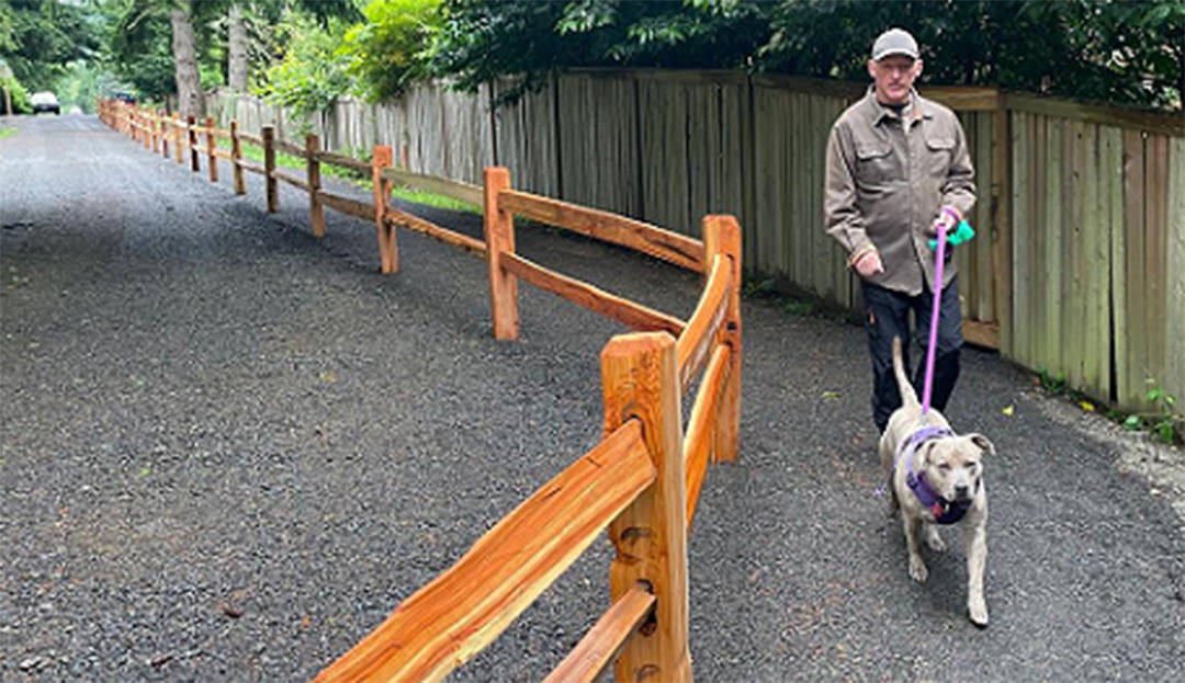 A fence separates the trail from the driveway. Courtesy Photo