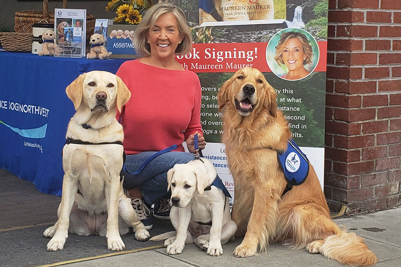 Maureen Maurer, local author and founder of Assistance Dogs Northwest, with a few of her service dogs (left to right) Sadie, Indy and Samson, during her book signing last week at Eagle Harbor Books. Tyler Shuey/Bainbridge Island Review