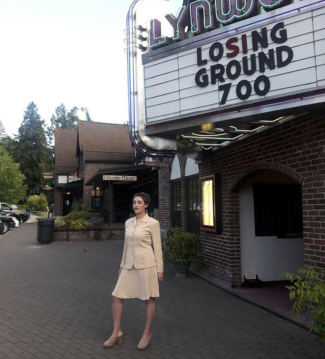 Courtesy photos
Local film curator and essay writer Tova Gannana stands outside the Lynwood Theatre dressed in attire that reflects the times of the movie she’s showing.