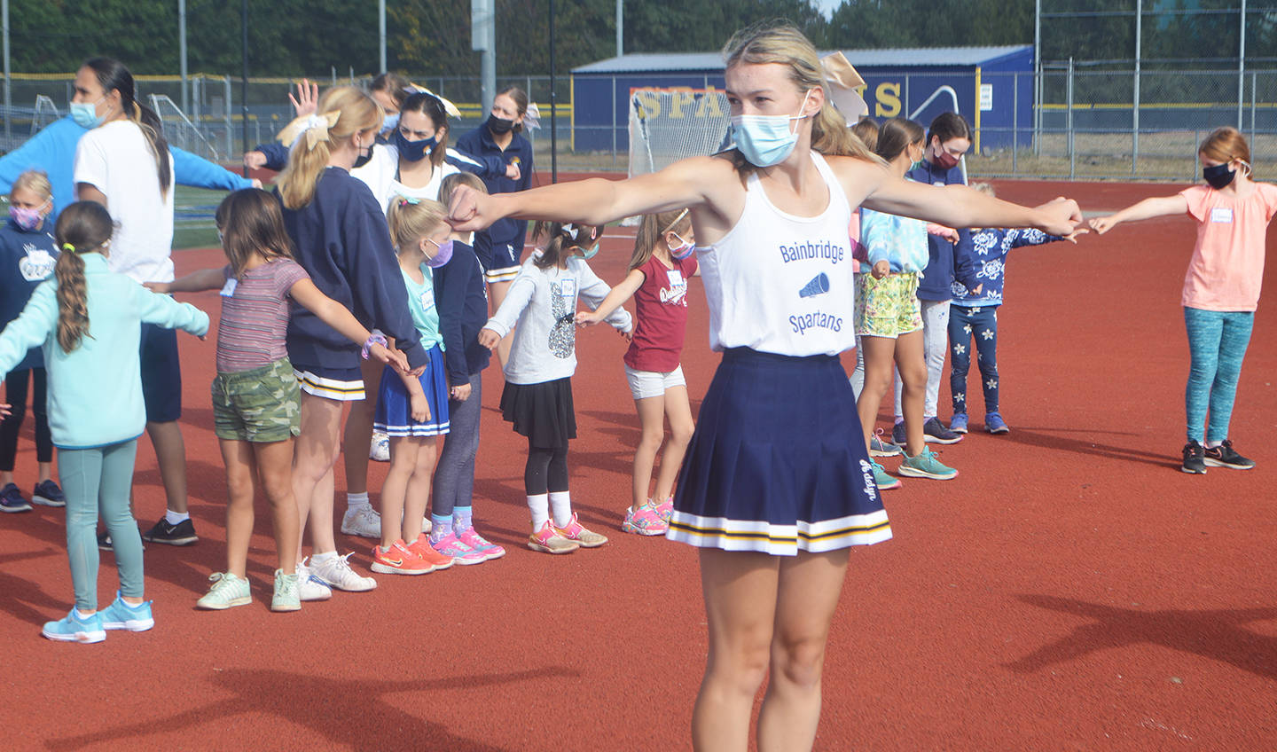 Bainbridge High School cheerleader Addy Ledbetter shows the youngsters the “T” formation.
