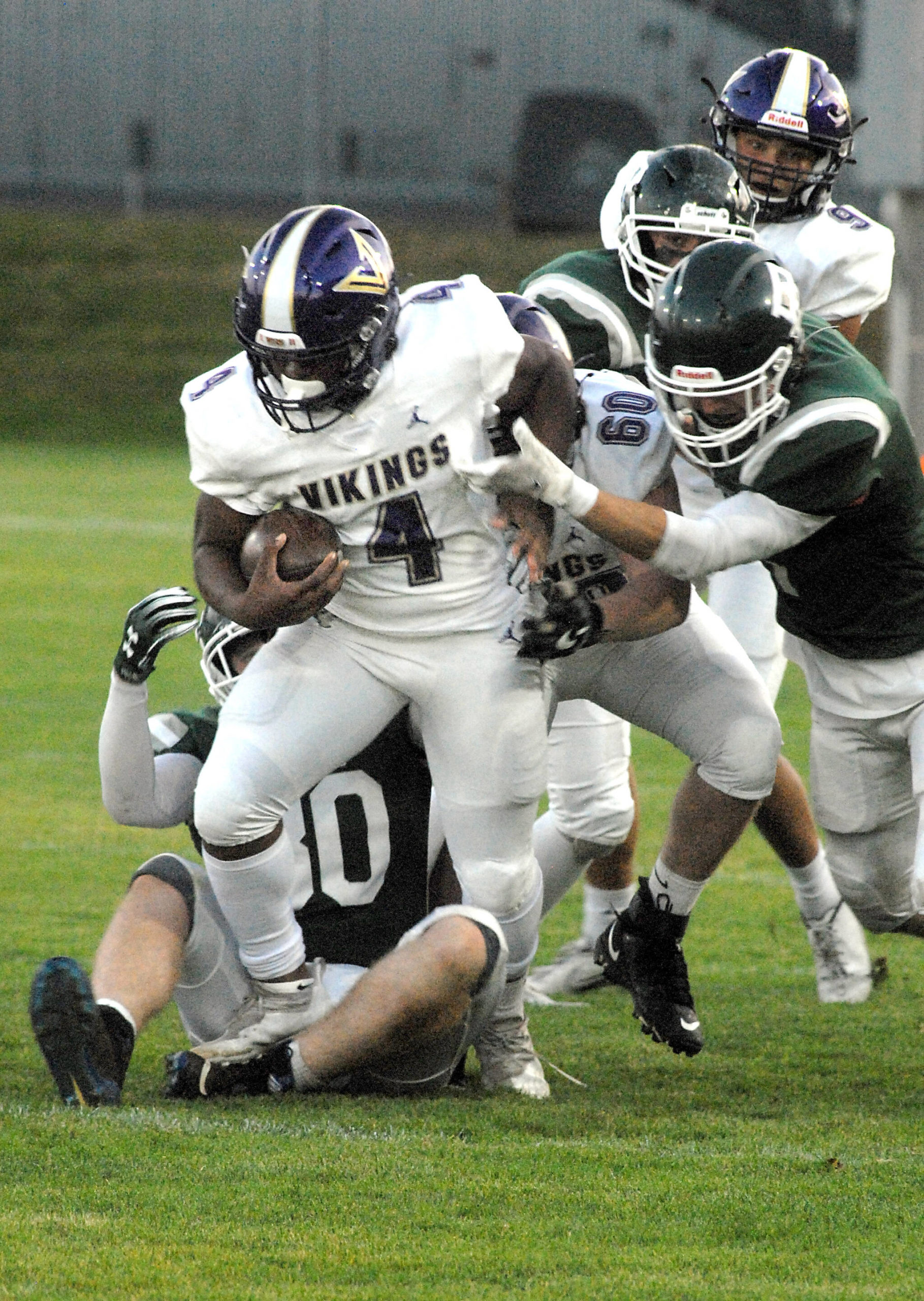 North Kitsaps Zeke Harris, front, gets an assist from teammate Lincoln Hawkins before being wrapped up by the Port Angeles defense on Friday night at Port Angeles Civic Field. (Keith Thorpe/Peninsula Daily News)