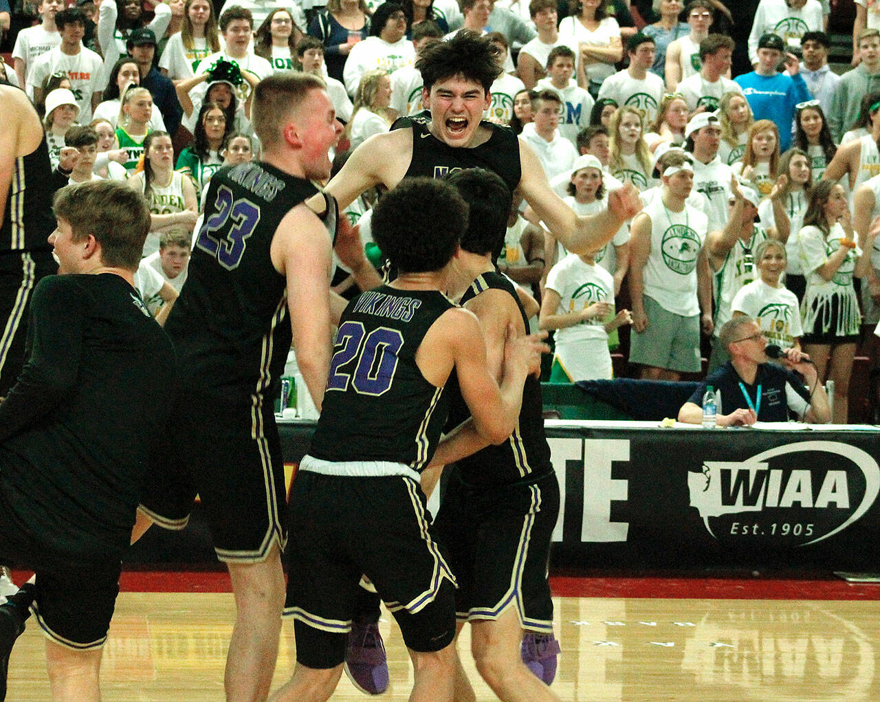 The North Kitsap boys basketball team celebrates after pulling off an improbable comeback in the semifinals in the 2A state tournament against Lynden. (File photo)