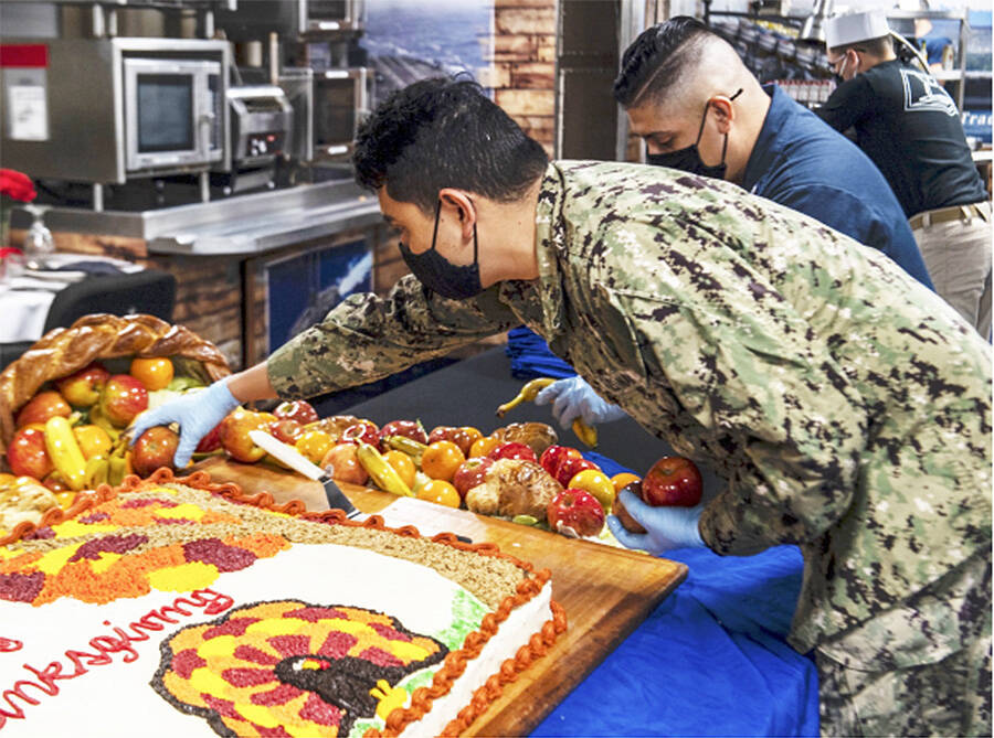 Sailors prepare Thanksgiving dinner aboard the aircraft carrier USS Nimitz, which is in port in Bremerton conducting routine operations. Navy Courtesy Photo