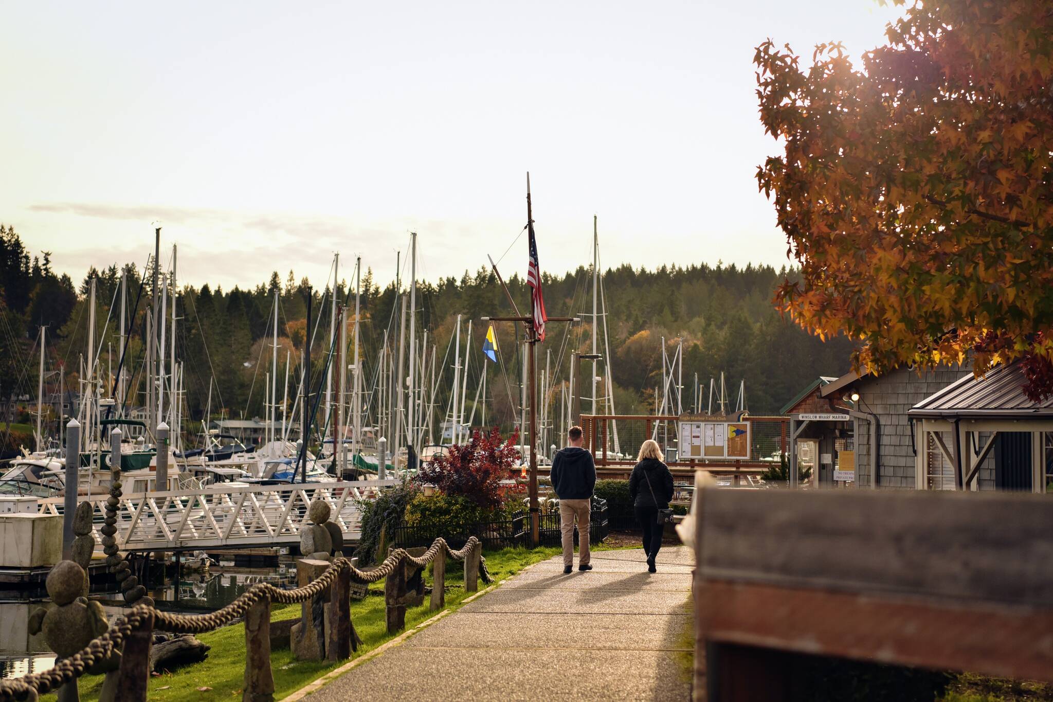 A couple walks along the boardwalk at the Winslow marina.