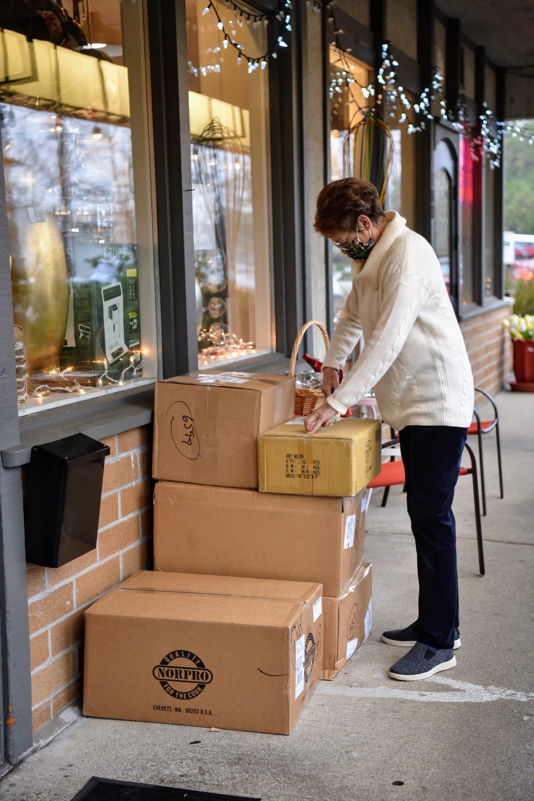 Berry Patch owner Jane Pomeroy unboxes items for her kitchen store that has been in business for 51 years.