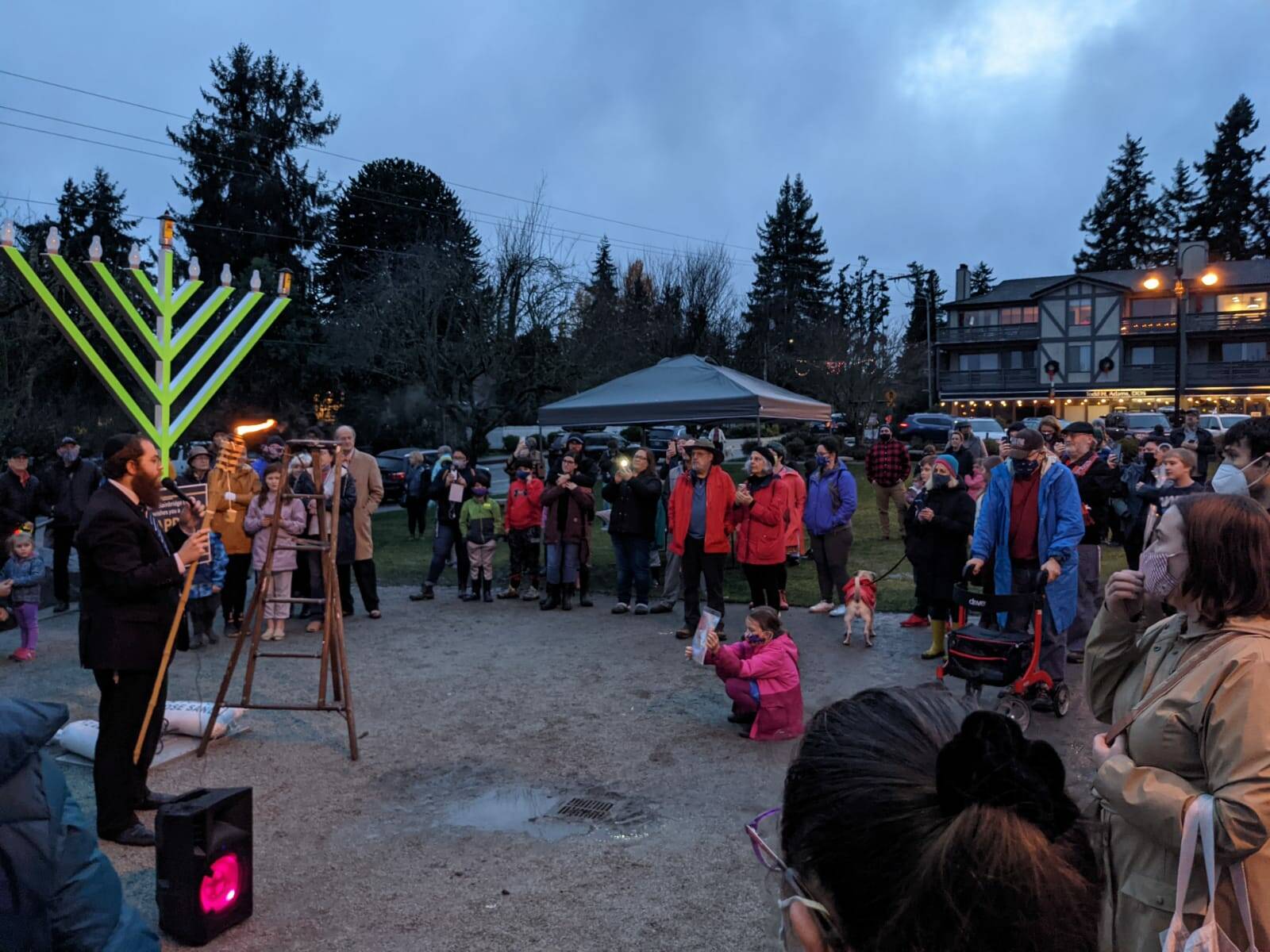 A large group gathers on Winslow Green in observance of the first night of Hanukkah. Photos courtesy of Rabbi Mendi Goldshmid.
