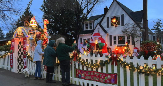 Jackie Callaham West, in green, shares her Christmas display with friends Mary Schoonmaker and Nancy Rekow at 296 Ferncliff Ave. NE. West has been adding to her holiday lights each season for 52 years. Nancy Treder/Bainbridge Island Review photos