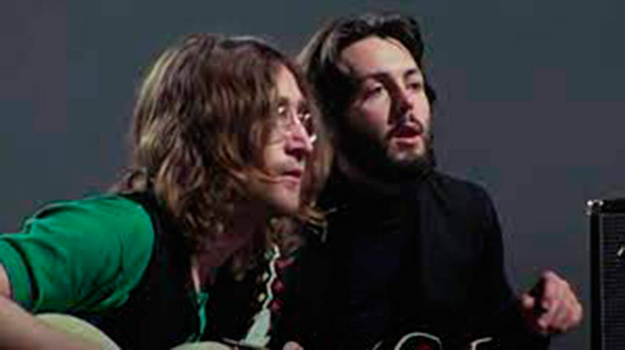 All eyes are focused on “Get Back” protagonists John Lennon (left) and Paul McCartney.