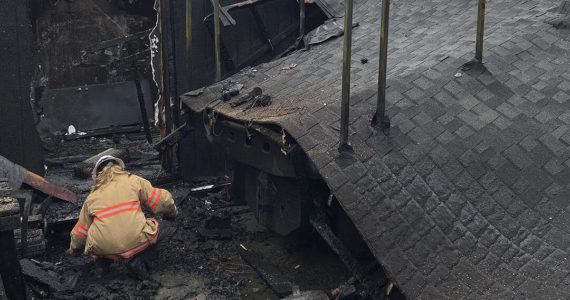 A firefighter checks through the damage. Courtesy photos