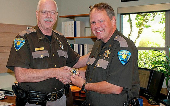 File photo
Now-retired Kitsap County Sheriff Gary Simpson presents John Gese (right) with a new sheriff’s badge.
