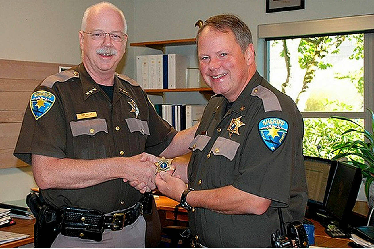 File photo
Now-retired Kitsap County Sheriff Gary Simpson presents John Gese (right) with a new sheriff’s badge.