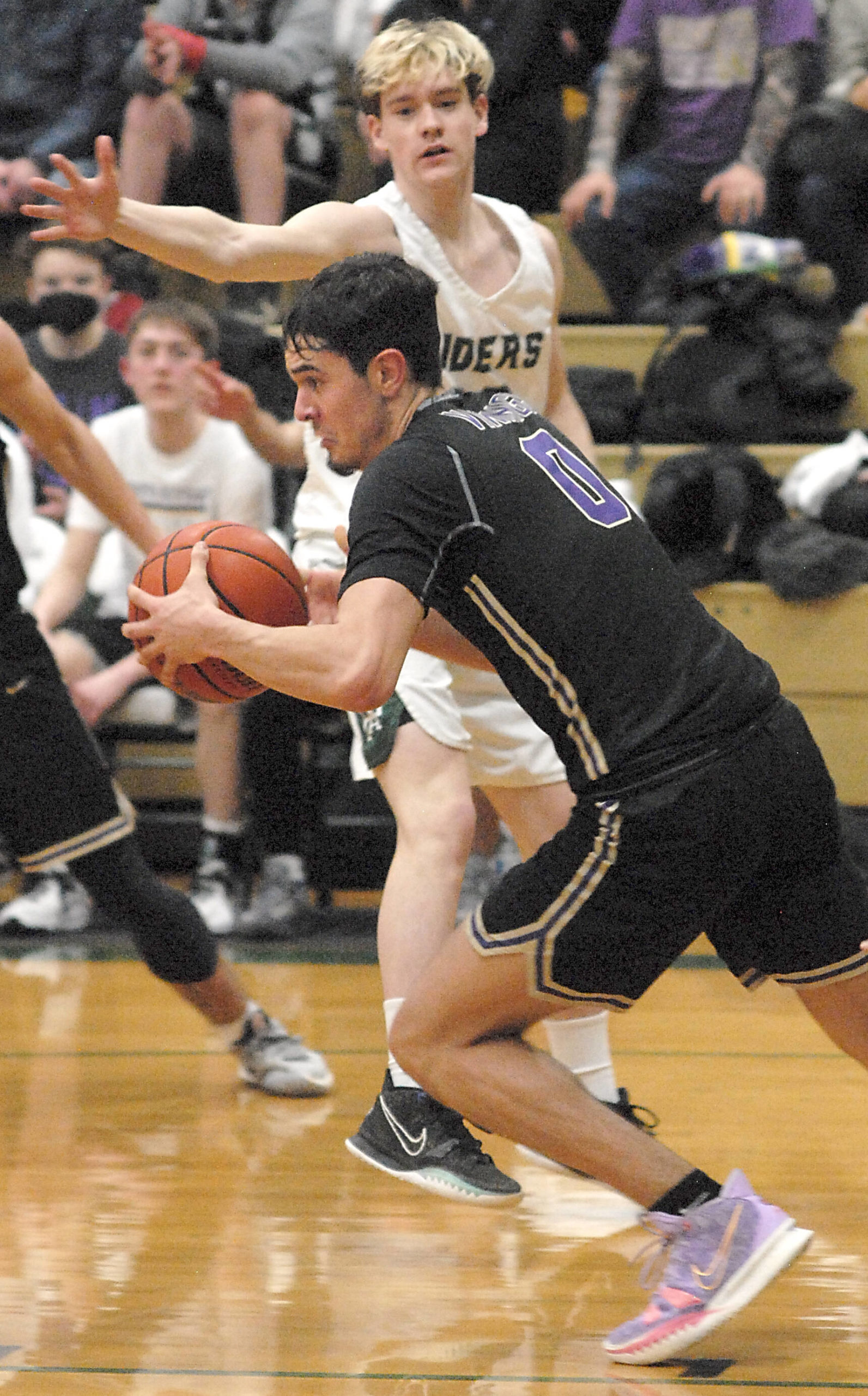 North Kitsap’s Johny Olmsted (0) gets the Viking fastbreak started against Port Angeles last Thursday night. PA, however, was able to slow down NK to get the win. Keith Thorpe/For the Herald