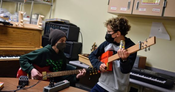 Nancy Treder/Bainbridge Island Review 
Sixth-grader Rowan Toler and fifth-grader George Wolffe make music with an electric guitar and cigar box banjo.