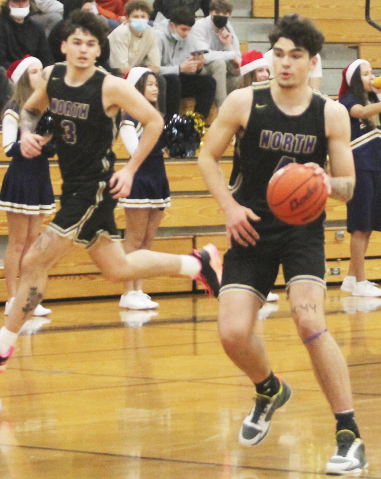 Jonas La Tour dribbles down the court while Aiden Olmstead fills the outside lane. Steve Powell/File Photos