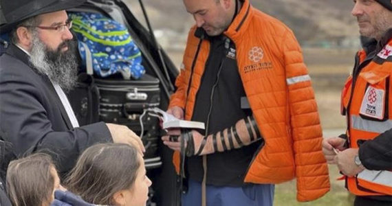Chabad.org/News courtesy photo
Above: Rabbi Yechiel Shlomo Levitansky and his family, left, talk with paramedics heading to Ukraine. After the rabbi visited with folks via Zoom in Bainbridge his family escaped from the turmoil. At left, Rabbi Mendi Goldshmid, shown here lighting the Menorah, is getting Bainbridge Islanders to help people in Ukraine.
