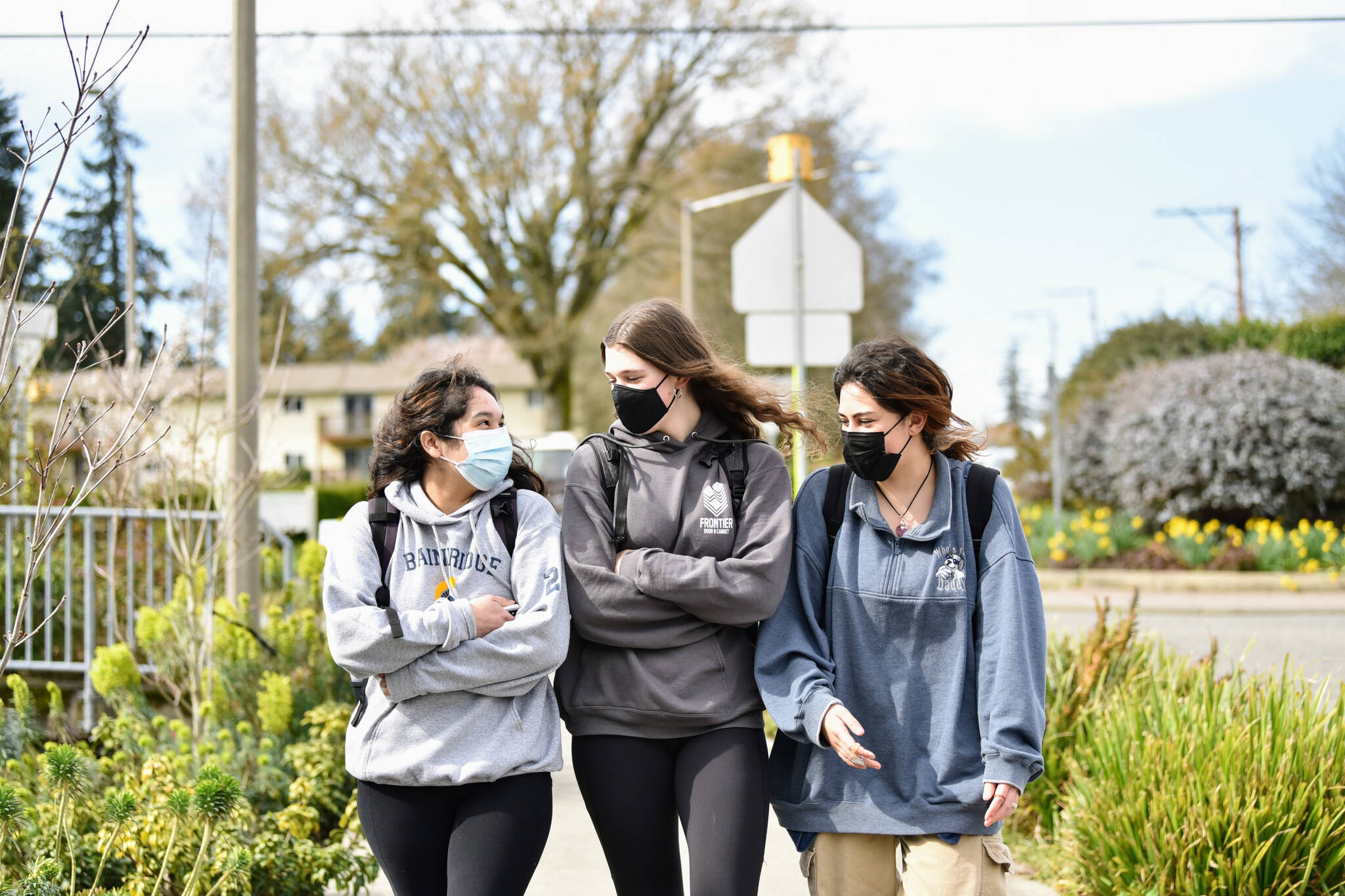 BHS juniors Olivia O’Rourke, Rain Malzahn and Laura Carrillo walk to lunch Tuesday. They are adjusting to the change by wearing or removing their masks as they feel comfortable.