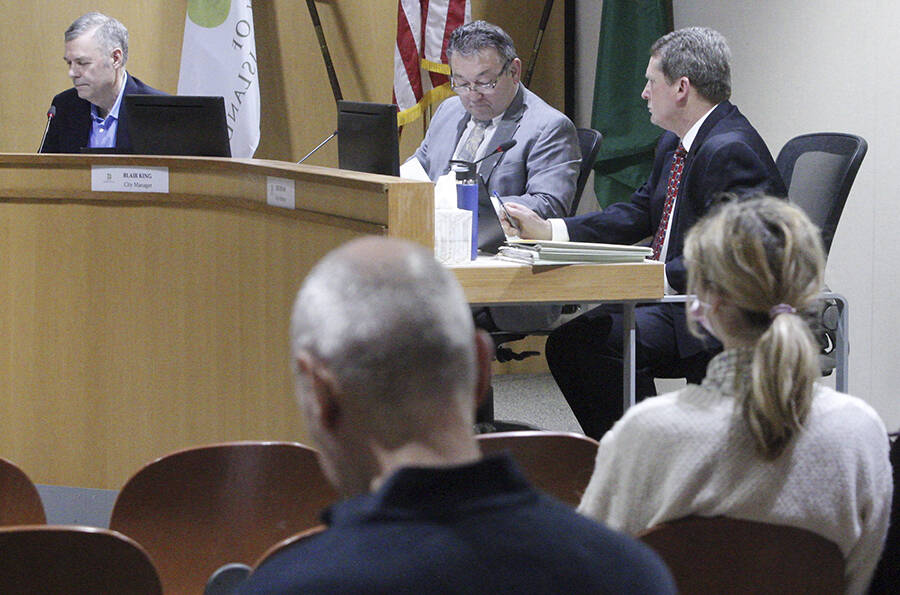 Mayor Joe Deets, left, and the rest of the Bainbridge Island City Council met in person in front of an audience for the first time in two years due to COVID Tuesday night at City Hall. Also shown are city manager Blair King and city attorney Joe Levan. Steve Powell/Bainbridge Island Review