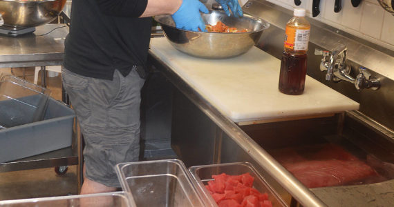 Josh Trebe mixes up a salmon dish in the kitchen. Steve Powell/Banbridge Review photos