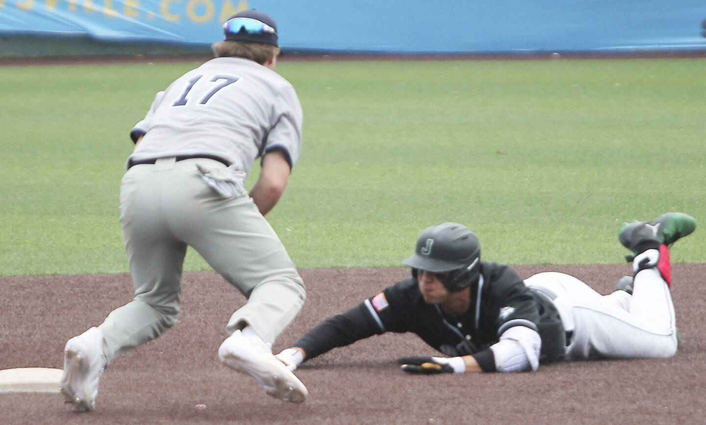 Joey Hildebrandt (17) gets set to tag Jackson’s Dominic Hellman, but he slid in safely for a stolen base.