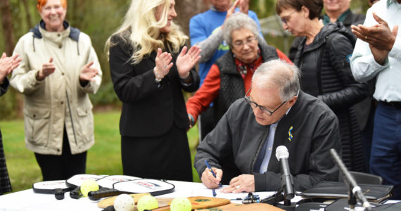 Gov. Jay Inslee signs a bill making pickleball the official state sport. Nancy Treder/Bainbridge Review photos