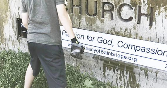 A Scout clean up the sign at Bethany Lutheran Church on Bainbridge Island. Courtesy Photo