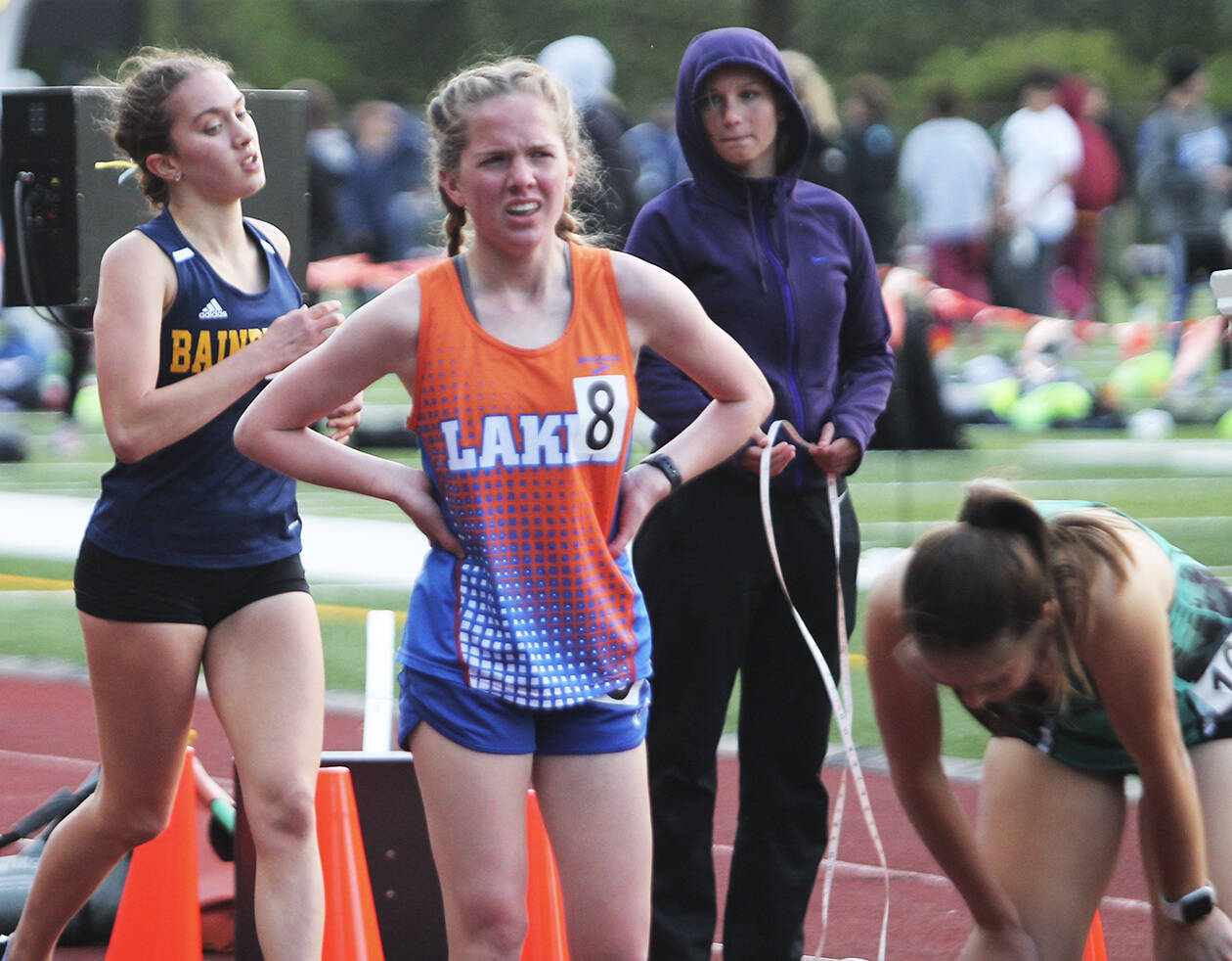 Eden Michael of Bainbridge crosses the finish line in the 1600 as others catch their breath.