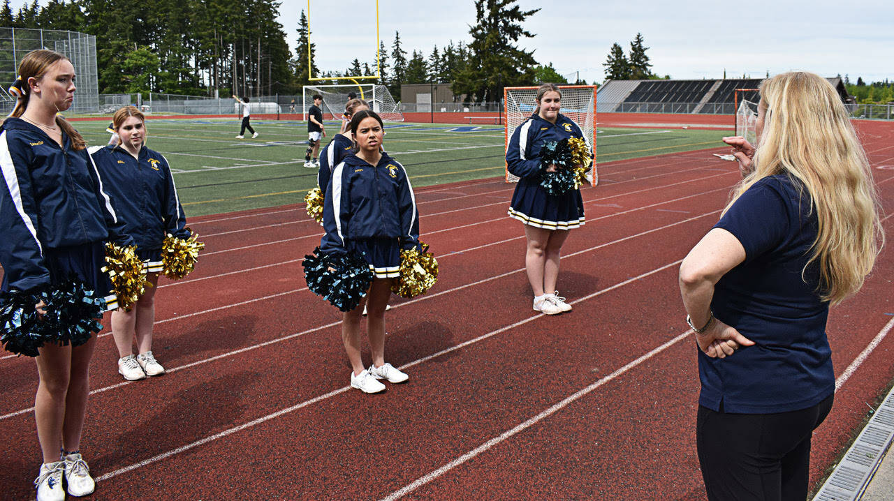 Tawnya Jackson watches her varsity cheer squad perform its own routine during practice.