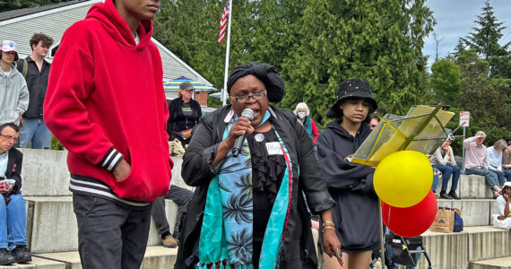 Karen Akuyae Vargas, center, addresses the crowd during the inaugural Juneteenth celebration with Izaya Brown and Justice Brown at Waterfront Park. Nancy Treder/Bainbridge Review photos