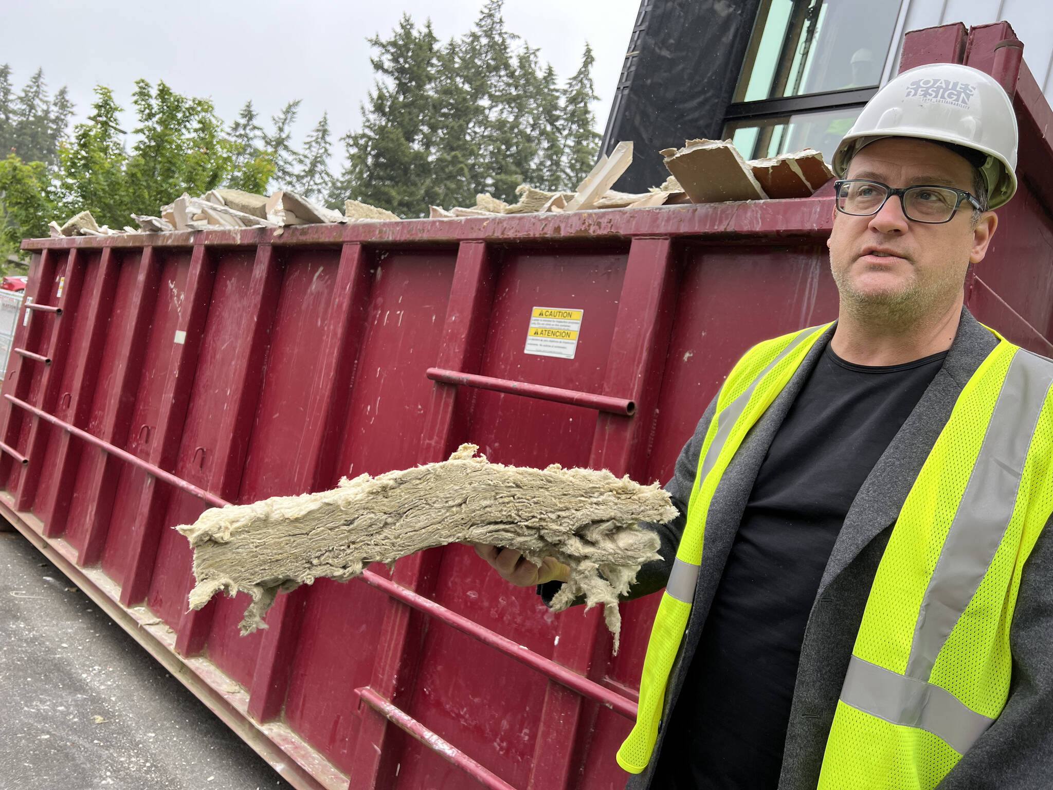 Matthew Coates holds a piece of mineral wool insulation slated for reuse. The material is made from rocks, is non-toxic and non-flammable.
