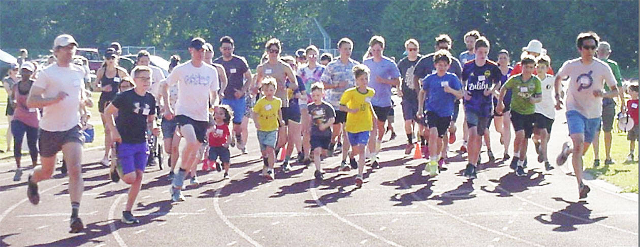 A larger group takes off in a race with folks of all ages.