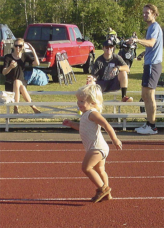 A young girl sprints to the finish line.