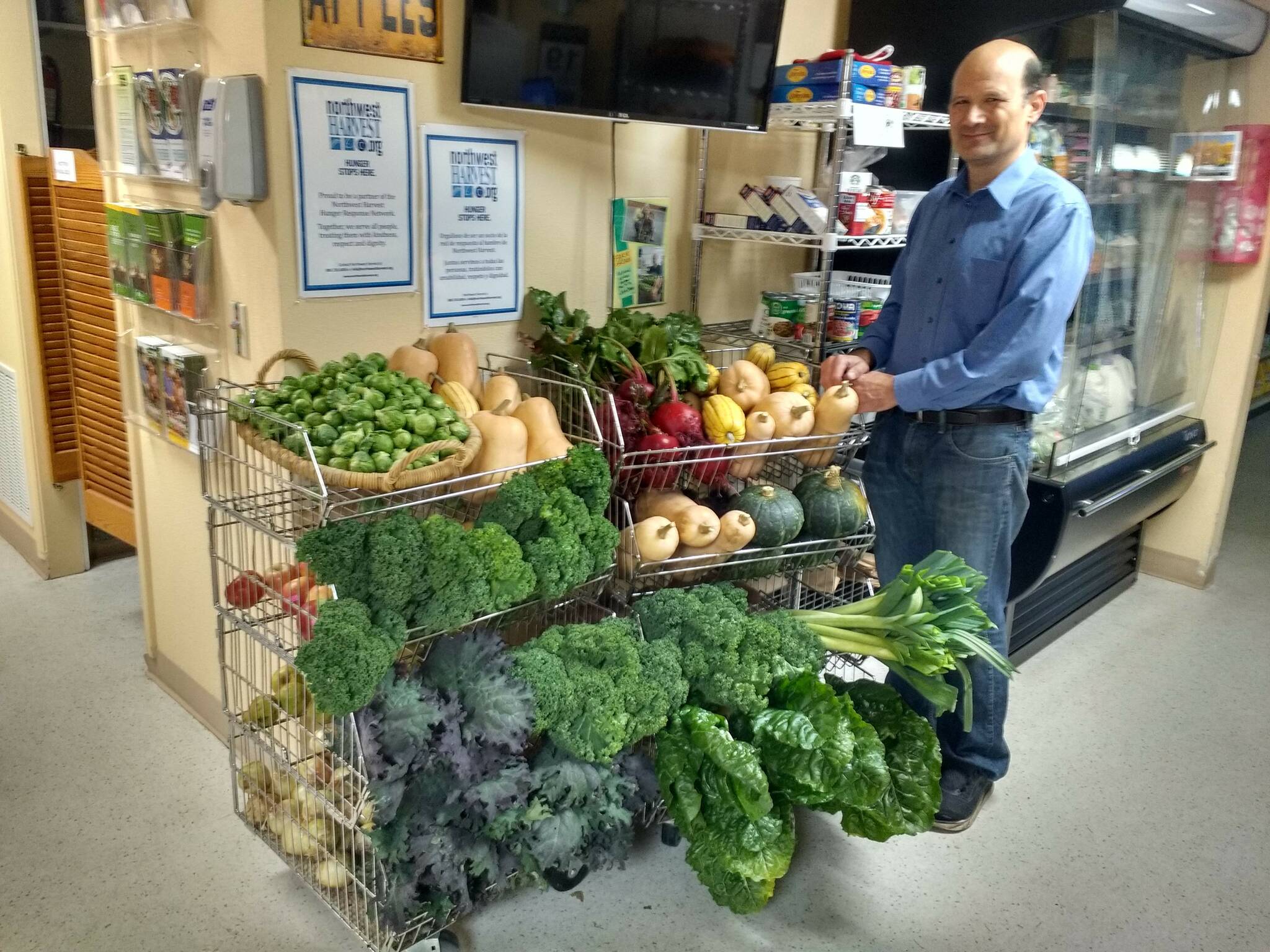 John Chang with a Peaceful Morning Farm delivery on display at the food bank.