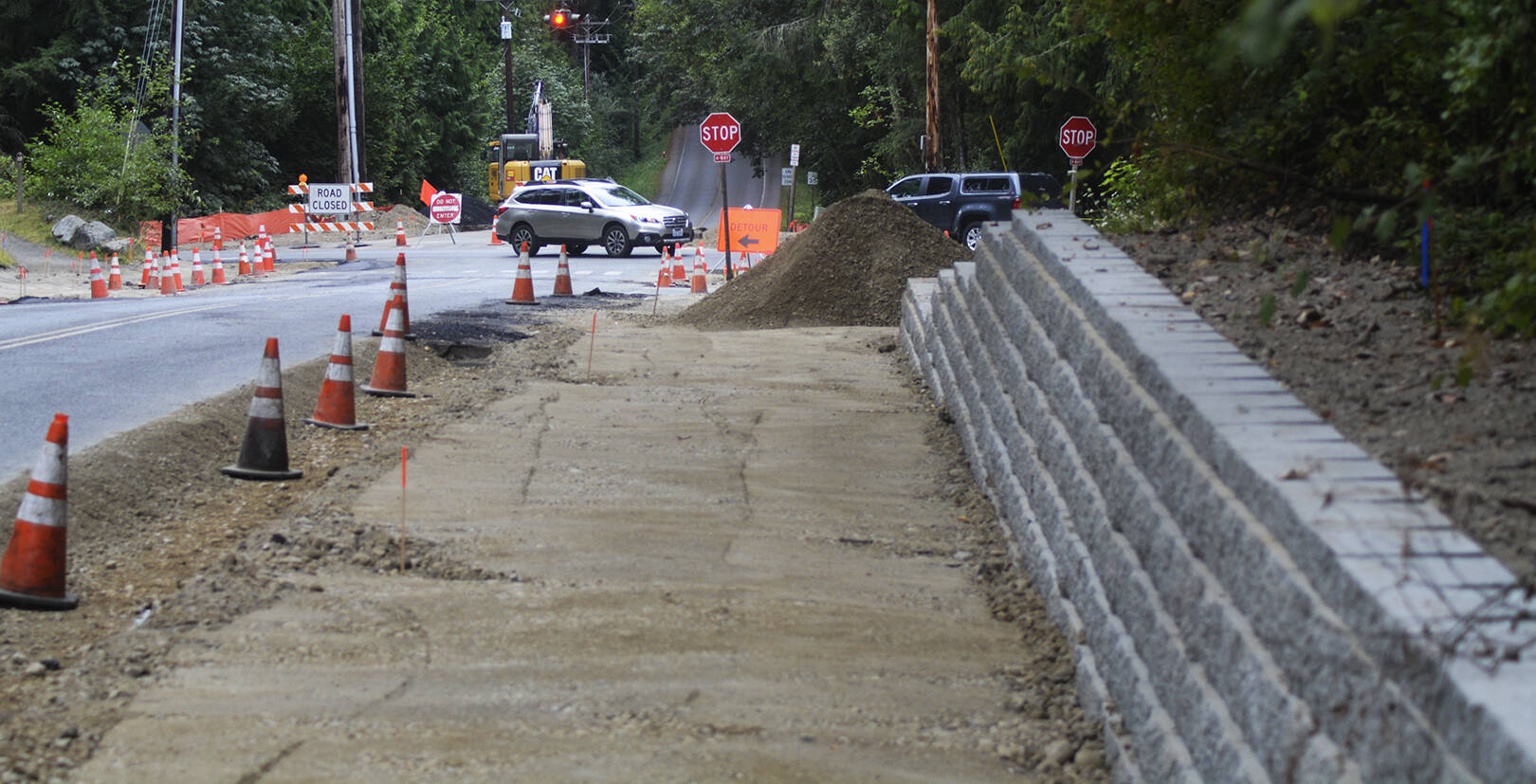 Some nice brickwork serves as a wall next to a wide sidewalk under construction. Steve Powell/Bainbridge Island Review