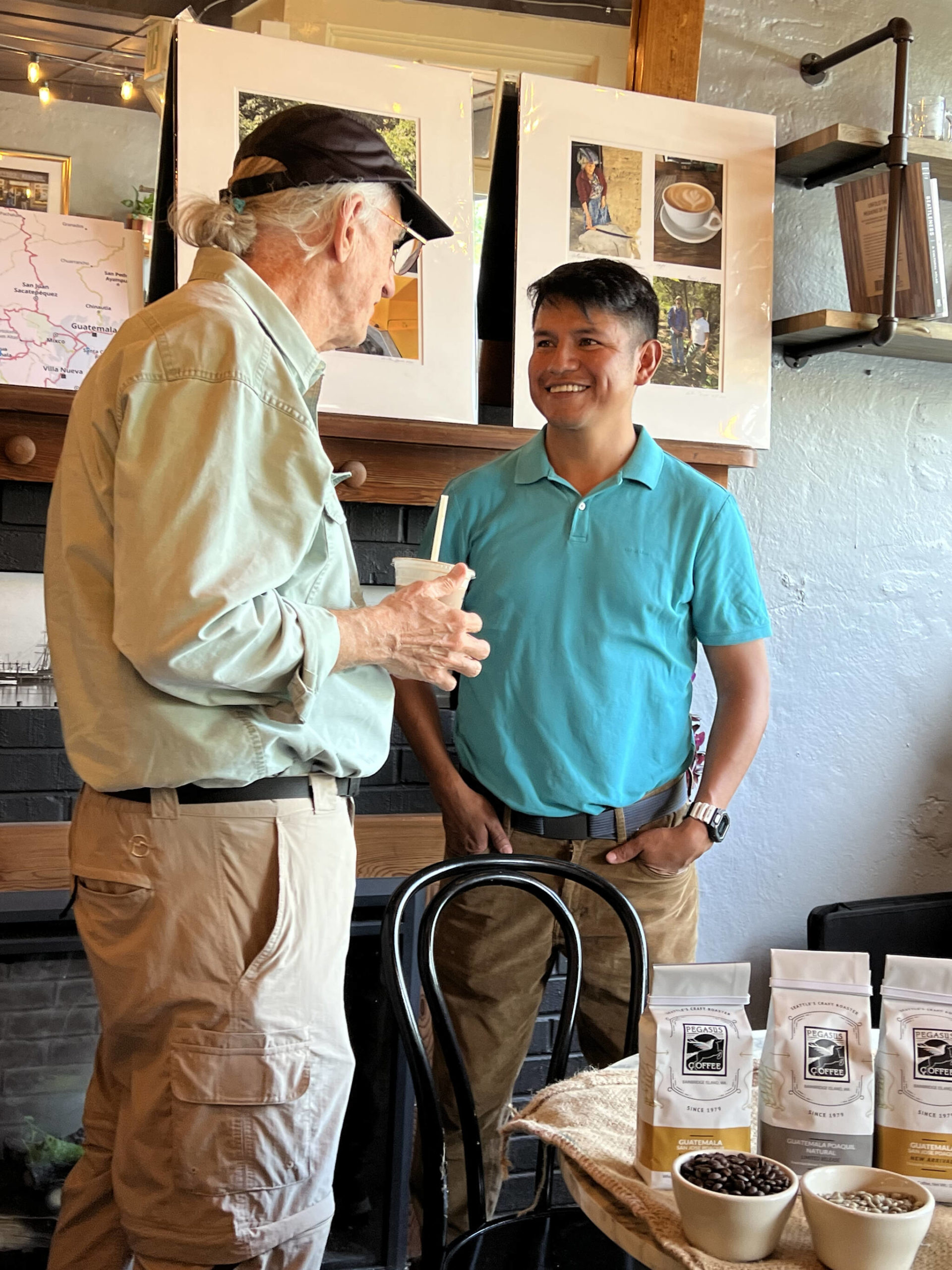 Gerson Morales speaks with a visitor about direct trade of organic coffee and sustainable growing practices. Nancy Treder/Bainbridge Island Review Photos