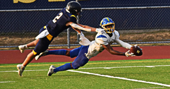 Johnny Breen reaches out to stop the Hazen wide receiver from making the catch. Nicholas Zeller-Singh/Bainbridge Island Review Photos