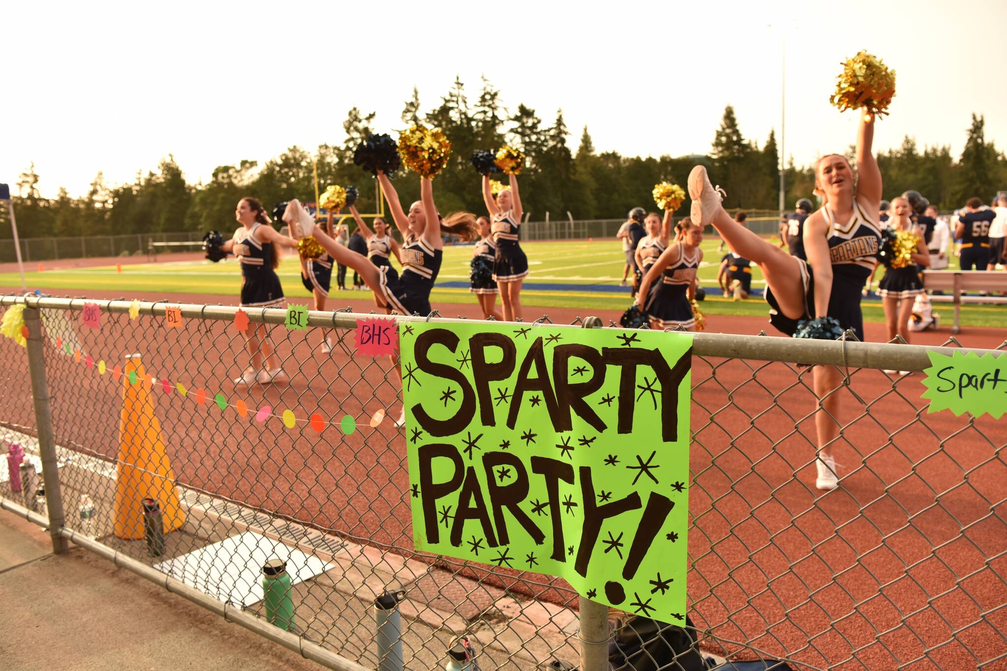 Signs and the cheerleaders show their Spartan spirit.